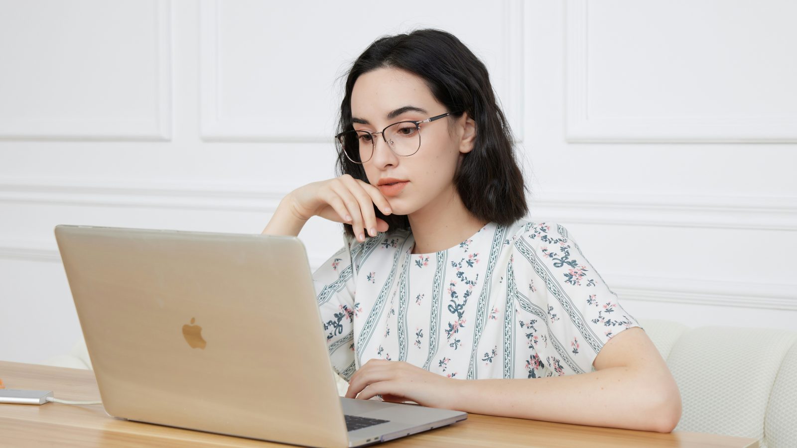 A woman sitting in front of a laptop computer
